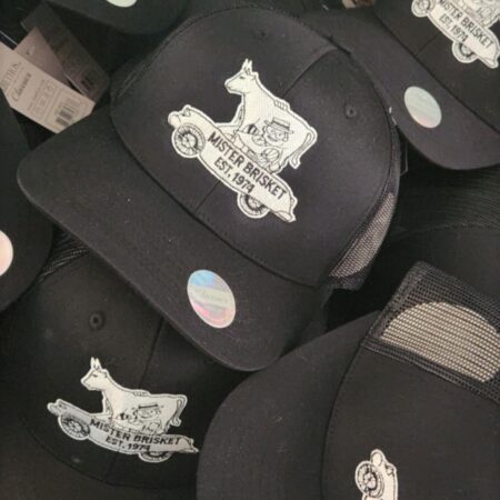 Mister Brisket Hat. Available in black with a black and white logo on the front. Snapback design allows for one size fits most.